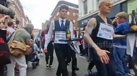 Participants of the annual Waiters' Race in London's Soho go wild, spraying crowd - and themselves - with fizz