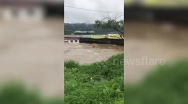 Swollen river gushes under bridge as heavy rains hit South Korea