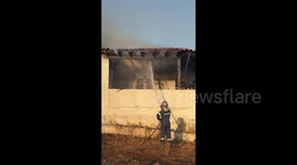 Firefighter Extinguishes House Fire Caused By Wildfires in Athens, Greece
