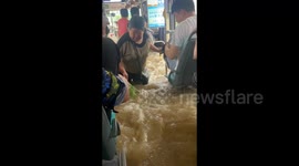 Chinese city confronts heavy rainfall and devastating flash floods as typhoon Talim makes landfall