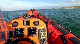 Poole lifeboat volunteers rescue paddleboarder blown a mile out to sea