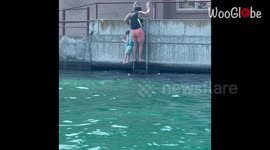 Husband lovingly gets his wife a drink on boat by swimming across *Wholesome*