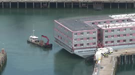 Moment controversial Bibby Stockholm barge docks at Portland Port