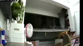 Powerful winds brought by typhoon Talim blow down balcony window in China