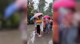Buddhist followers push through religious parade despite heavy storm