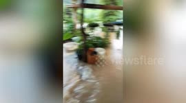 Floods caused by monsoon storm surge through homes and roads in southern Thailand