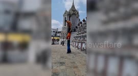 Chinese tourists show off human pyramid acrobat moves outside Thai temple
