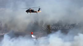 Helicopters battle wildfires fuelled by strong winds in Turkey