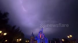 Visitors cheer as lighting storm lights up Cinderella Castle at Disney World's in Orlando, US
