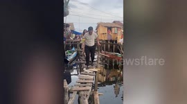Above and beyond! Kind teachers climb through fishing village slums to reach pupils