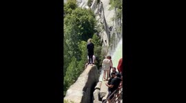 Yosemite Tourists Stand Near Waterfall Edge