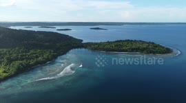 A strong old woman fisherman from Mentawai, rowing her own canoe into the ocean to support her family