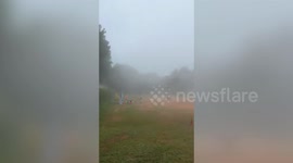 Eerie time-lapse footage shows pupils disappearing into thick fog on school field in Thailand