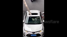 Motorist narrowly avoids death as drainage pipe plunges from overpass in China