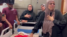 Mourners gather by the body of Palestinian Mohammed al-Bayyed who was killed during clashes with Israeli forces while a protest against Israeli settlements in the village of Umm Safa, at a hospital in the Wes Bank city of Ramallah