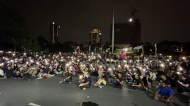 Thai protesters wave mobile phone lights at rally following country's sham election