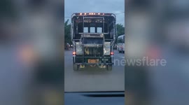 Hitchhiking stray cat rides on back of bus in Thailand