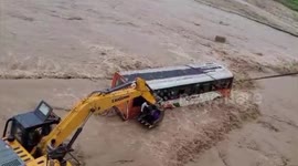 Bus with passengers inside gets trapped in overflowing river