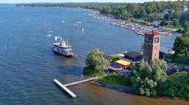 The Chautauqua Belle steamboat and the Bell Tower on Chautauqua Lake, captured in the afternoon light by drone