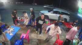 Chaos as storm sends tables and chairs flying while diners attempt to eat outside