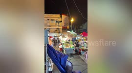 Sudden strong storm blows stall parasols on market in Thailand