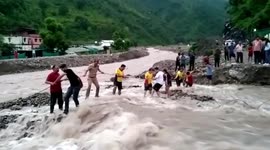 Indian rescuers and locals form human chain to save residents amid devastating floods