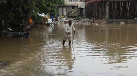 Mud invades houses and streets amid devastating floods in India's Gujarat