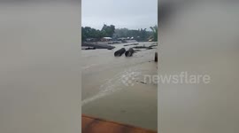 Locals cross river swollen from Super Typhoon Doksuri rain in the Philippines