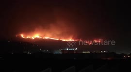 Flames and smoke line the horizon as wildfires rage across Sicily