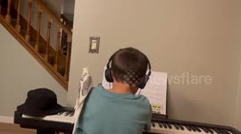 Cockatiel sits on owners shoulder and sings along to the piano