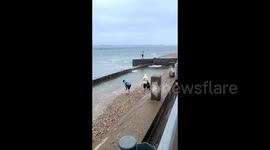 Quick-thinking friends save man swept away by surprise sea wave in China
