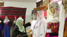 Palestinian woman Laila Shaheen, displays the artifacts and traditional clothes in her museum