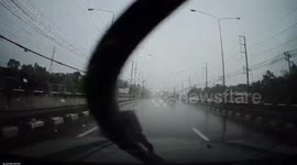 Quick-thinking driver avoids electricity post falling onto road during storm