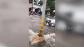 Cars drive through flooded highway as Super Typhoon Doksuri hits the Philippines