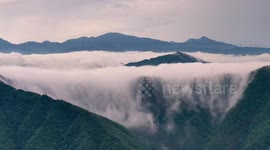 Sea of clouds cascades down Chinese mountains after rainfall
