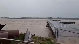 River swollen from Super Typhoon Doksuri surges under steel bridge in the Philippines