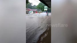 Locals wade through waist-deep floods from Super Typhoon Doksuri