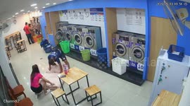 Couple battle to squeeze mattress into launderette washing machine
