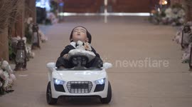 Toddler chosen as ring bearer falls asleep while riding toy car down the aisle