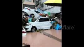 Record-setting rainfall pummels southern China, ravaging infrastructure and sweeping away vehicles