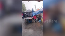 Vendors battle strong wind as storm pounds market in Thailand