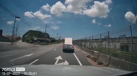 Gypsum board flies from back of pickup truck and slams into windshield of car behind