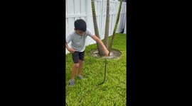 Fearless 9 y/o Snake Charmer catches an anxious black racer in a gentle manner