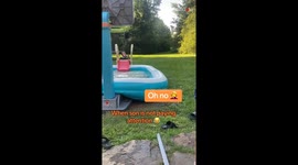 Boy walking backwards, saying goodbye, unexpectedly falls in the swimming pool