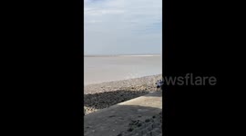 A Tourist Watching the Tidal Bore were Almost Swept away by the Rushing Water in Shaoxing, Zhejiang, China
