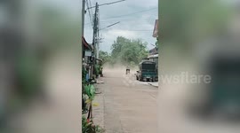 Dust storm sweeps through street in rural Thailand
