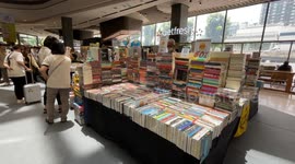 Bookworms enjoy pints while browsing through stalls at 'Books and Beers' fair in Bangkok