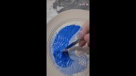 Ceramist exceptionally transforms a ceramic plate by coating it with glaze
