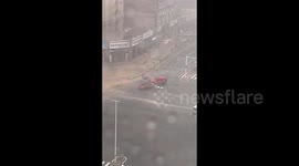 Two cars join forces to protect fallen man amidst typhoon's fury