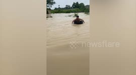Thai local turns monsoon misery into joy, makes waves on waterlogged street